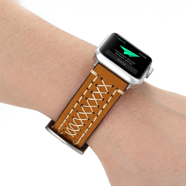 Genuine leather Apple Watch band on wrist, tan-brown with cream stitched rows and buckle