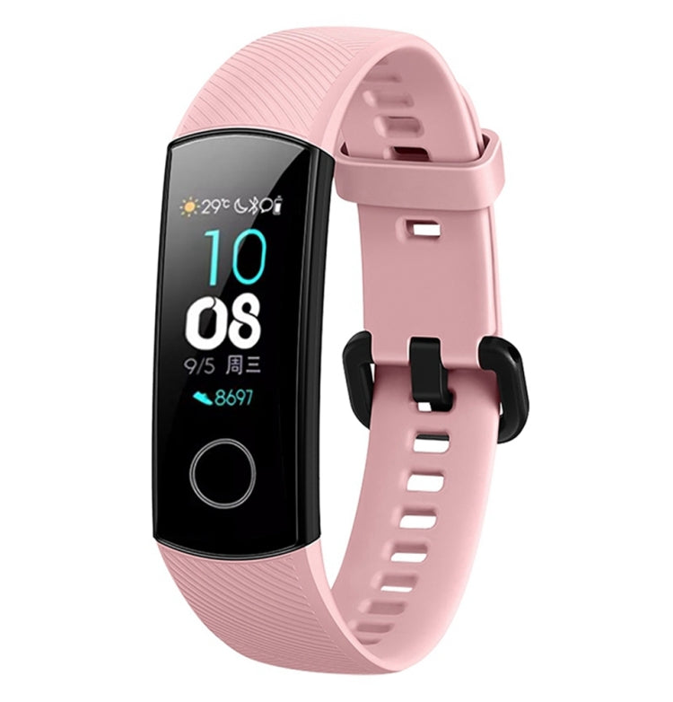 Pink silicone watch band with textured strap and adjustable buckle for fitness tracker