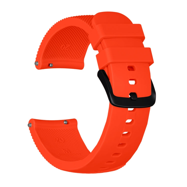 Orange silicone watch band with textured strap ends, metal pins, and adjustable holes