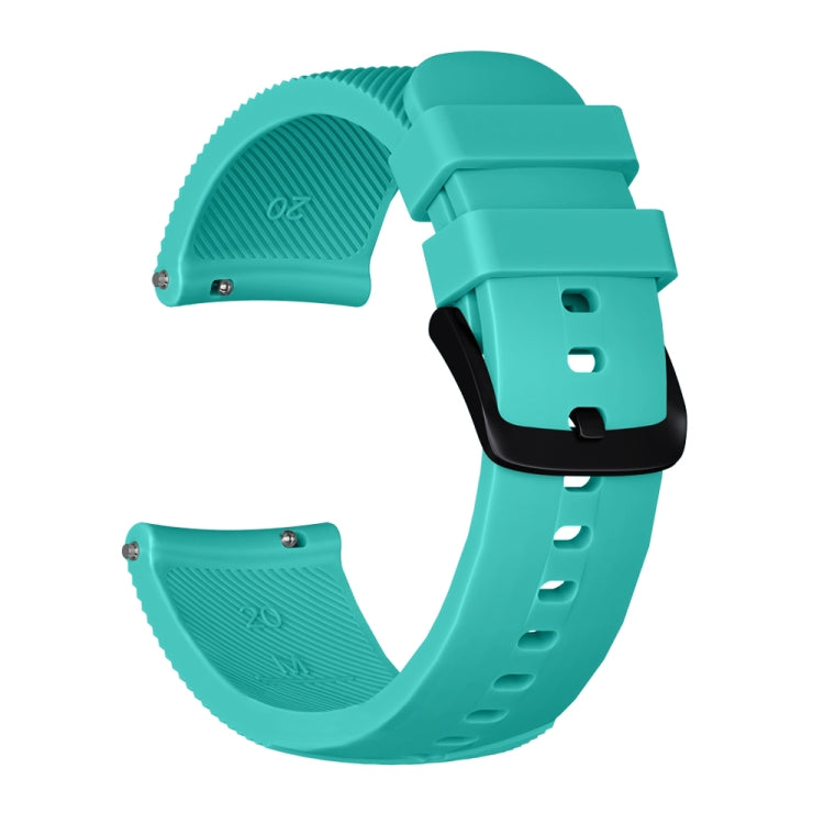 Mint green silicone watch band with textured ends, metal pins, and adjustable holes