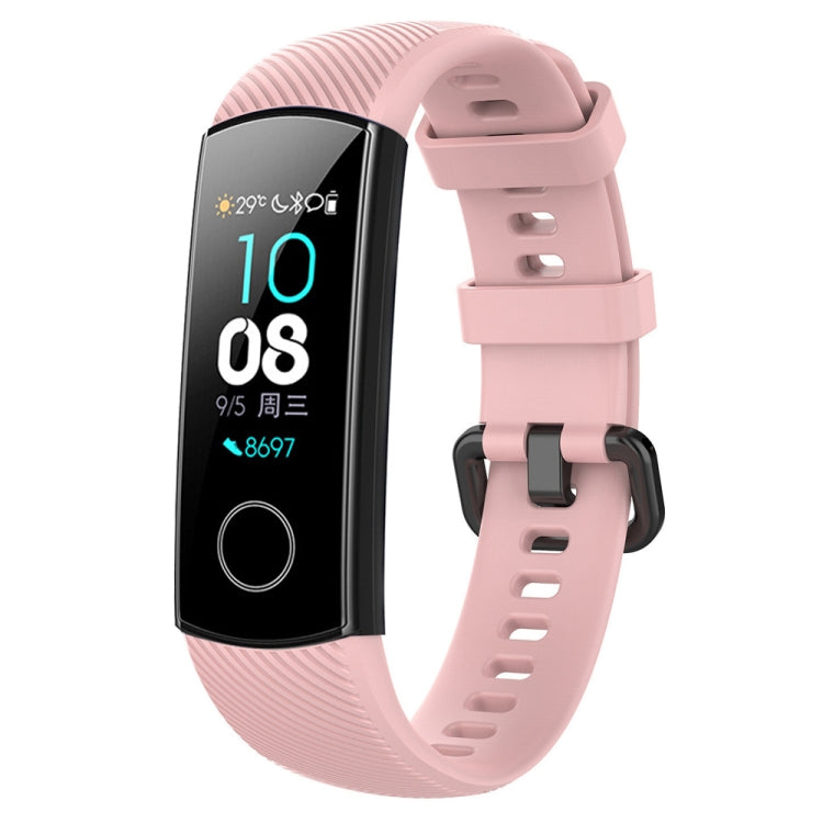 Pink silicone watch band with buckle and perforated strap, shown with smartwatch display