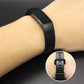 Black silicone smartwatch band on wrist with adjustable buckle and close-up clasp view