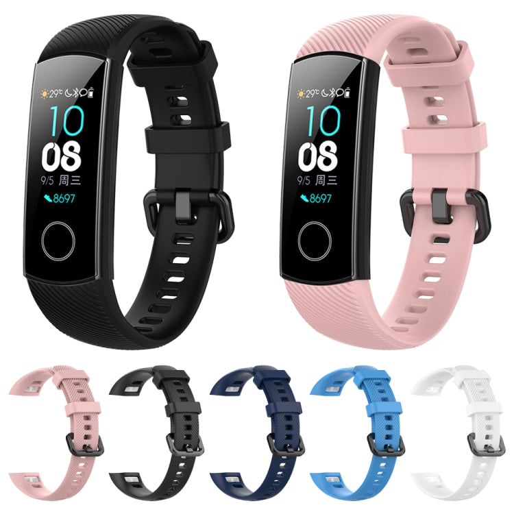 Set of silicone watch bands in pink, black, blue, and white with buckles