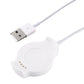 White charging cradle with circular charging surface and small pin contacts