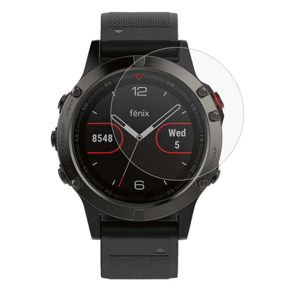 Tempered glass screen protector film on black Garmin smartwatch, clear round cover