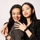 Two women wearing fitness smart watches with chain bracelets