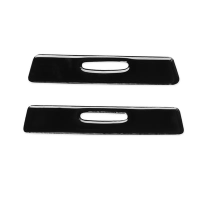 Pair of black car cup holder decorative stickers with oval slot cutouts