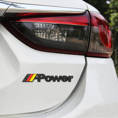 Car “Power” emblem sticker with Germany flag stripe on the edge of the rear light panel.