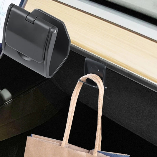 Hidden glove box hook with cord holding a shopping bag