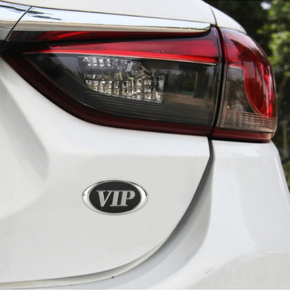 Oval VIP metal decorative sticker on a car panel, chrome rim and black center