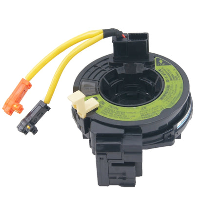 Clock spring assembly with black circular housing and yellow wiring harness connectors