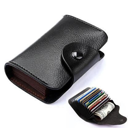 Black genuine leather card holder with snap flap and card slots, folded opening.