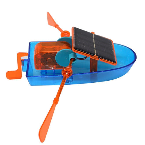Close-up of solar-powered toy boat with black solar panel and orange propeller