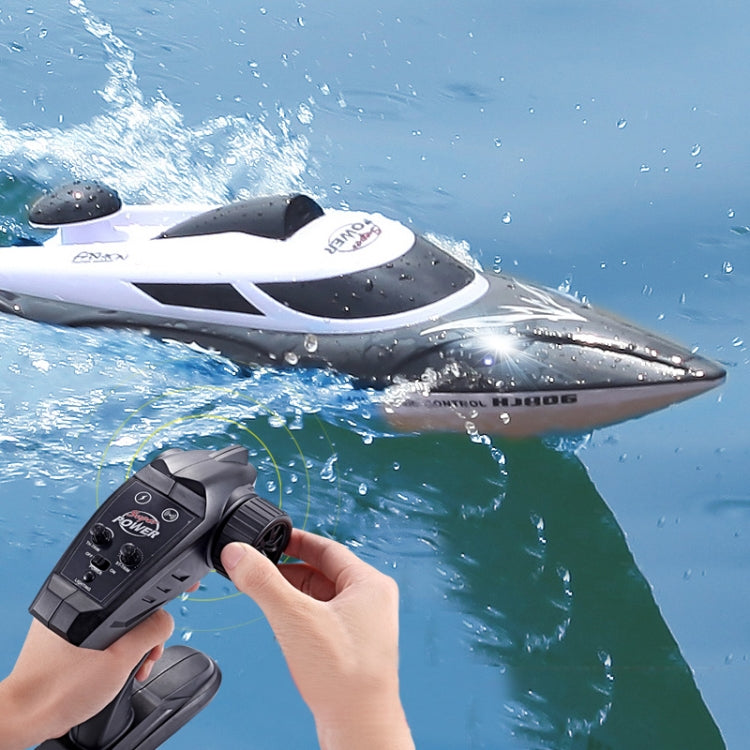 White and black remote control racing speedboat with handheld transmitter