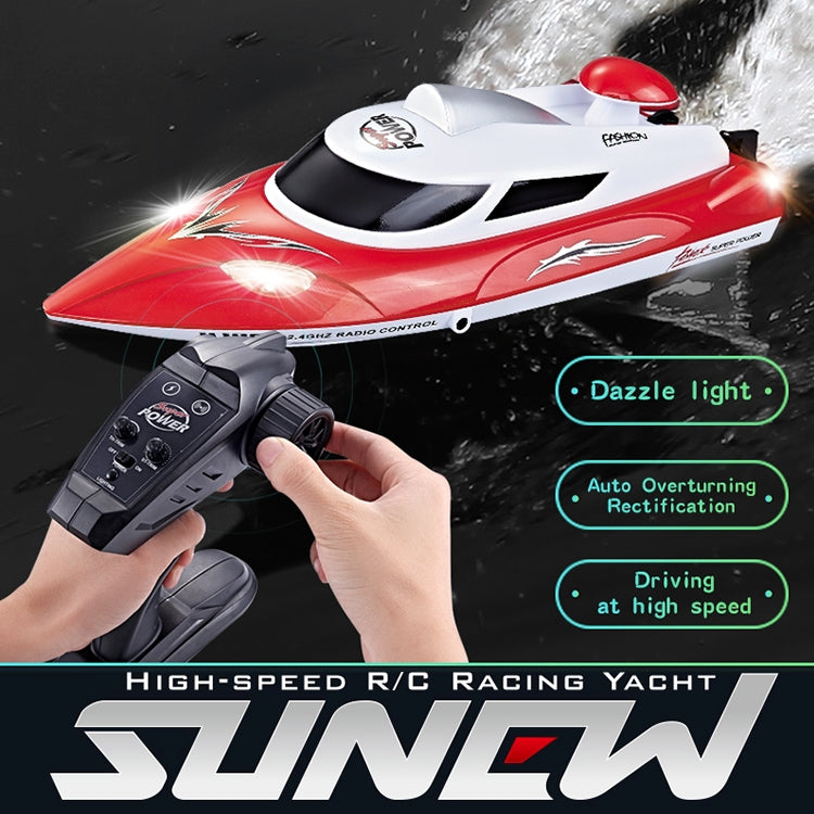 Red and white RC racing yacht with remote controller in hand, splashing water