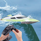 Green and white RC racing yacht with remote controller, close side view on water