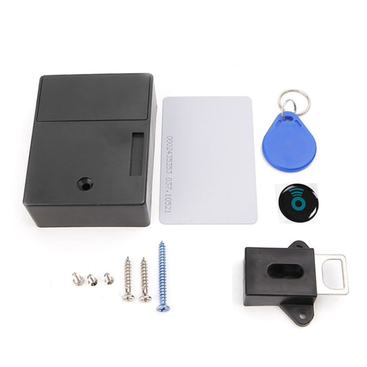 Magnetic cabinet lock set with black/white body, key fob, screws, and mounting parts