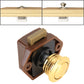 Press type cabinet latch with gold round release button and brown mounting housing