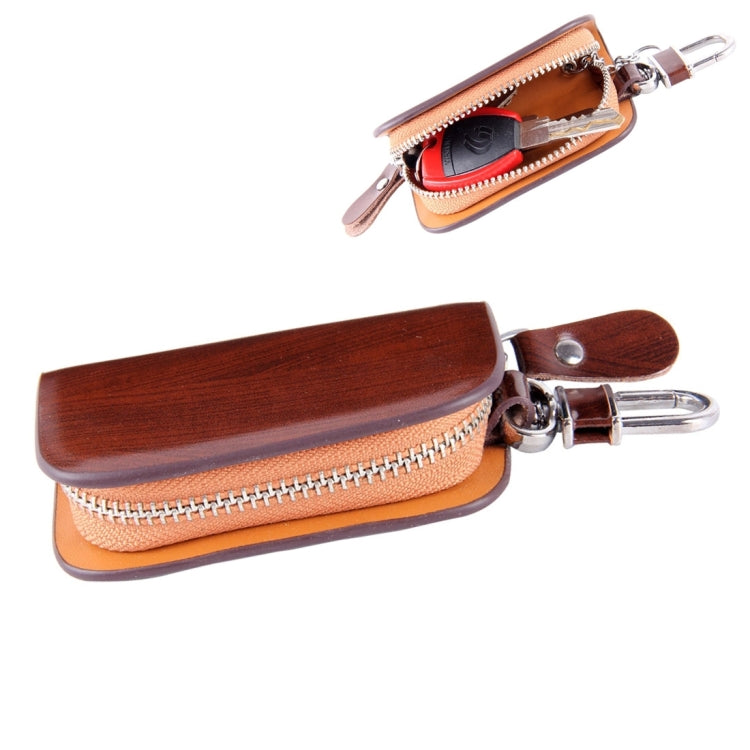 Brown wood-grain leather zipper key wallet with metal carabiner clip and loop pull.