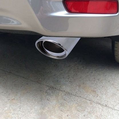 Stainless steel exhaust tail pipe on car bumper, round oval outlet, polished chrome finish