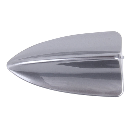 Silver shark fin car dome antenna cover with glossy finish and smooth edges.