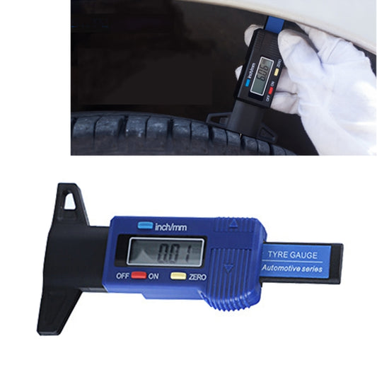 Blue digital tire tread depth gauge with LCD screen and black measuring foot, glove visible