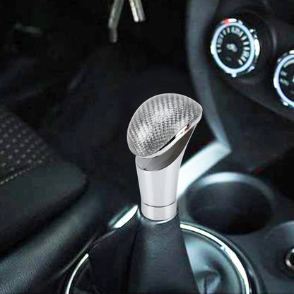 Car gear shift knob with carbon-fiber style top and chrome base, installed in interior