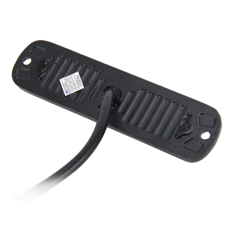 Black rear housing of an amber LED strobe light with mounting holes and cable
