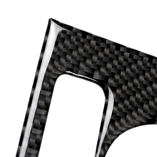 Carbon fiber rotary button sticker frame with circular opening, angled close-up