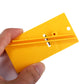 Hands holding yellow vinyl film cutter tool with two blade tracks