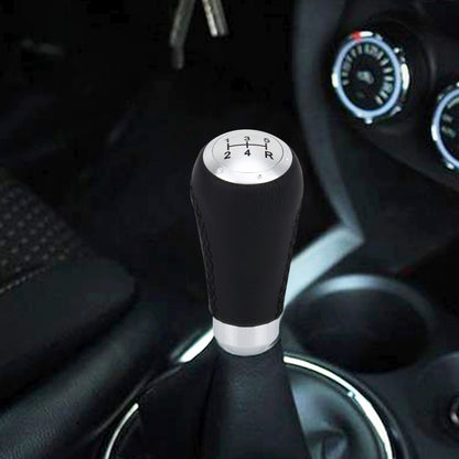 Black leather 5-speed manual gear shift knob with silver shift pattern top.