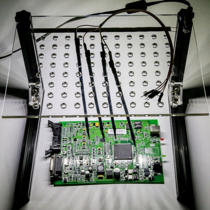 LED BDM test frame with metal probe arms, perforated board, and ECU circuit board base