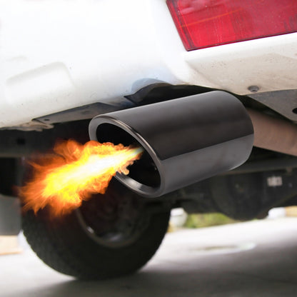 Black exhaust tailpipe muffler tip with round opening, showing flame at outlet