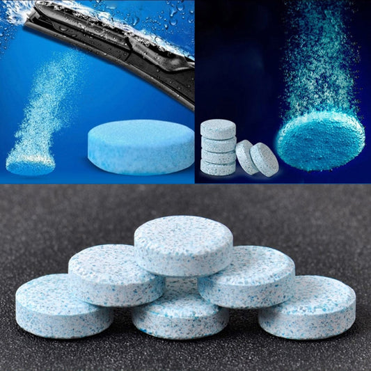 Blue-speckled car windshield glass cleaner tablets, solid discs with granule residue