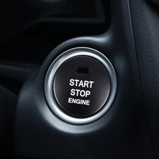Black circular engine start/stop button cover trim with “START STOP ENGINE” text
