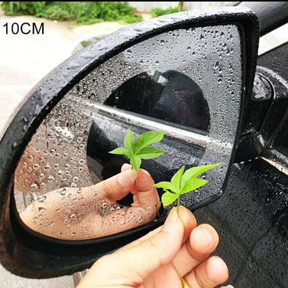 Car rearview mirror protective film being applied on a rain-covered side mirror