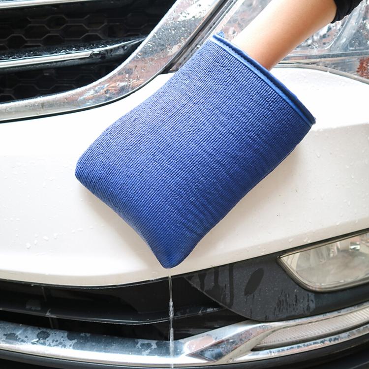 Blue microfiber car washer glove with cuff, pressing against vehicle body for wash