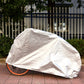 White bicycle cover draped over motorcycle-style wheels