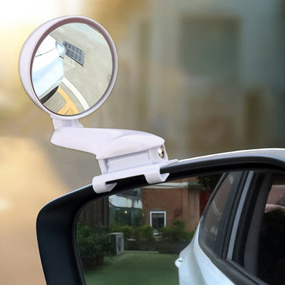 White adjustable blind spot mirror with wide-angle glass mounted on a car side