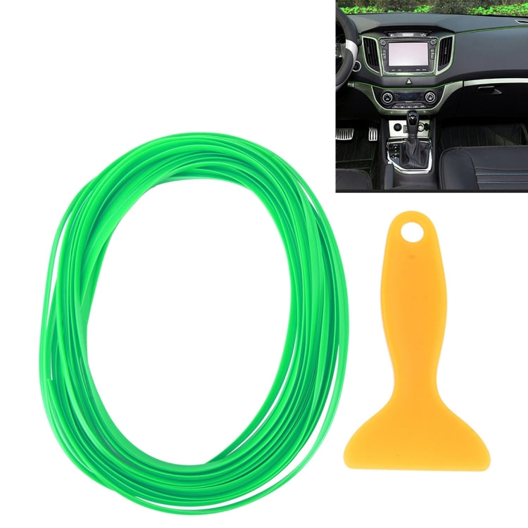 Green flexible car interior trim strip coil with orange scraper tool