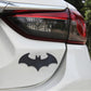 Metal bat car sticker with shiny black bat design on the rear of a white car