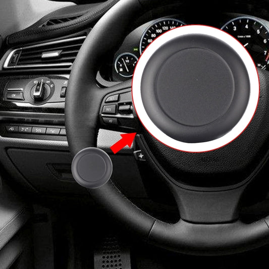 Black round steering wheel spinner knob accessory mounted on the steering wheel.