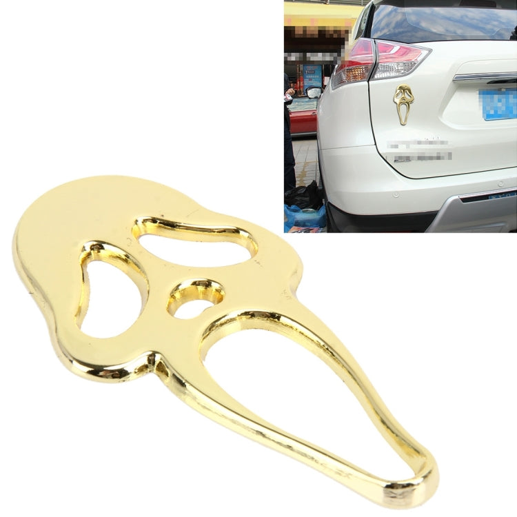 Gold elf-shaped metal car sticker with face cutouts