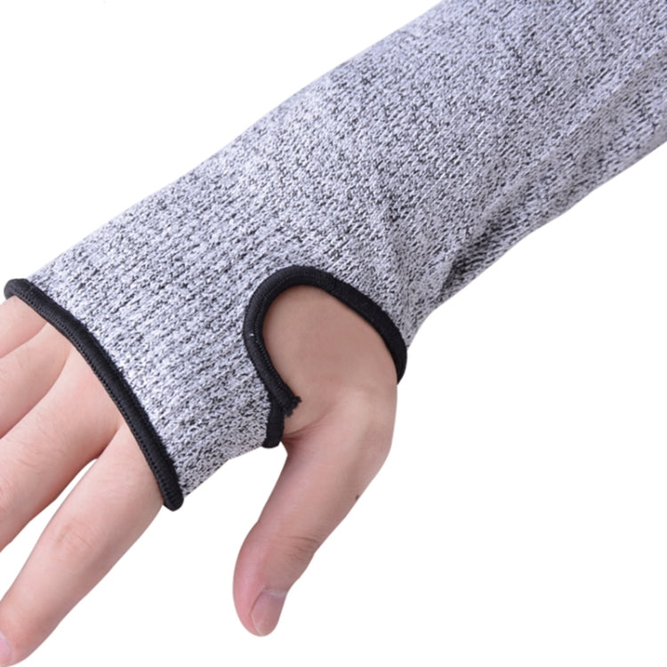 Grey elbow sleeve with black elastic cuff holding on securely on a hand.