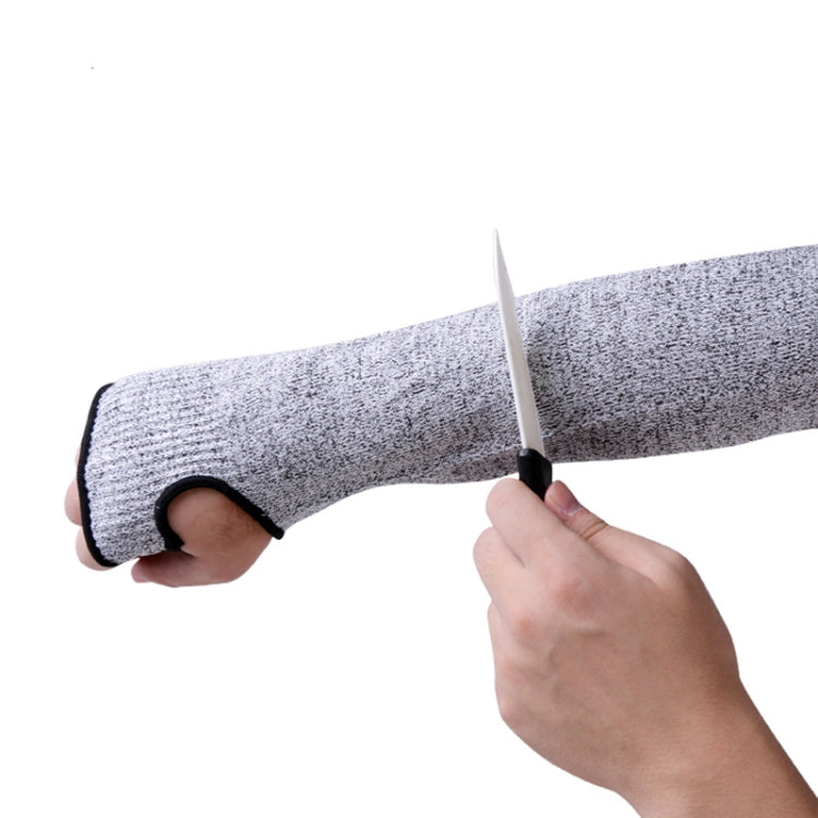 Grey elbow arm sleeve being held in place over an arm with black cuff opening.