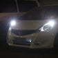 Car front showing bright white LED bulb glow near the headlight area