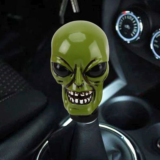 Green alien skull gear shift knob cover with black textured base and detailed teeth