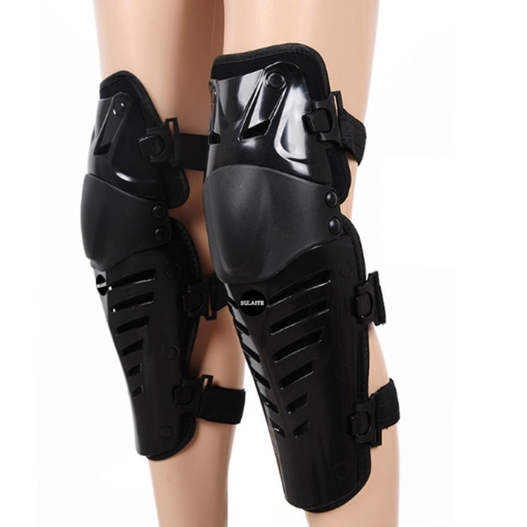 Black motorcycle knee protector covers on legs, featuring hard-shell plates and straps.