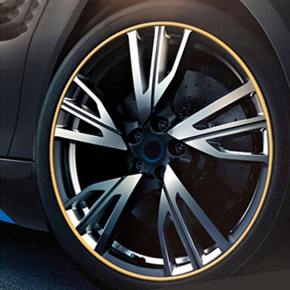Car wheel with gold shining rim trim strip around the tire edge