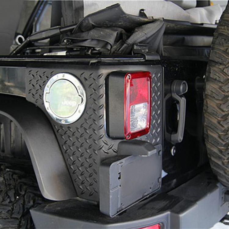 Rear license plate light housing installed on vehicle bumper panel, black plastic